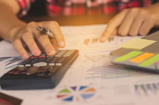 Businessman are working with a calculator and laptop. in office business concept 