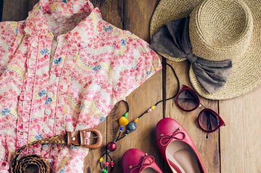 Clothing and accessories for women on wood floor for travel at holiday