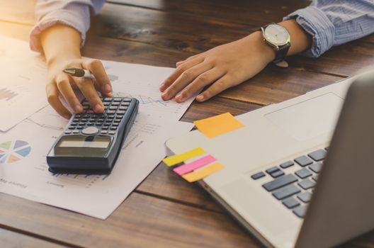 Businessman are working with a calculator and laptop. in office business concept 