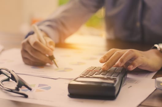 Businessman are working with a calculator and laptop. in office business concept 