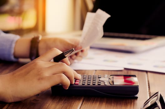 Businessman are working with a calculator and laptop. in office business concept 