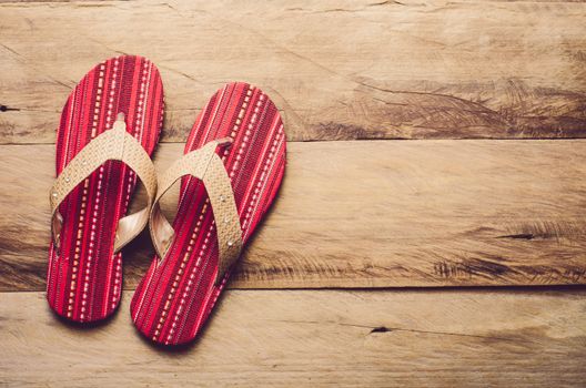 Red slipper on wooden