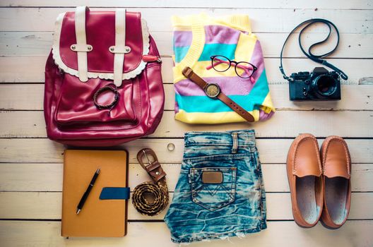 Tourism planning and equipment needed for the trip on wooden floor