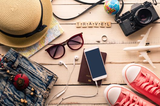 Tourism planning and equipment needed for the trip on wooden floor