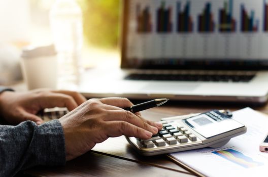 Working on a desk numerical analysis, financial accounting. Graphing Calculator on laptop