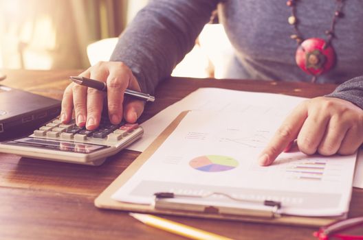 Businessman are working with a calculator and laptop. in office business concept 