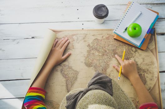 Traveler finding location for travel on the world map