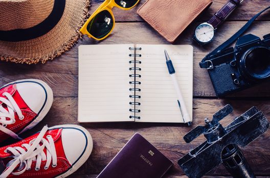 Tourism planning and equipment needed for the trip on wooden floor 