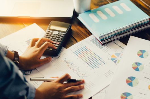 Businessman are working with a calculator and laptop. in office business concept 