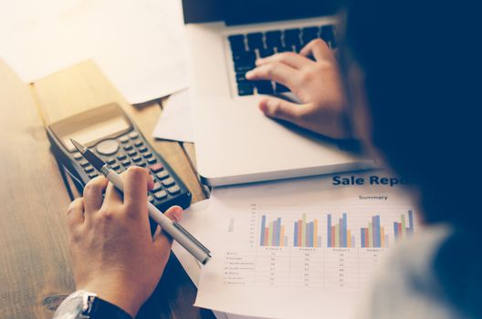 Businessman are working with a calculator and laptop. in office business concept 