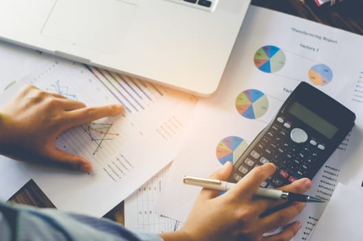 Businessman are working with a calculator and laptop. in office business concept 