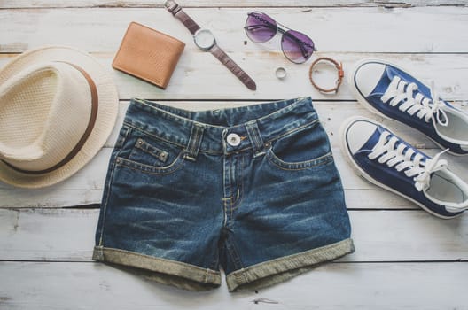 clothing for women, placed on a wooden floor.
