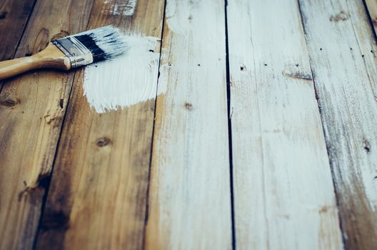 White brush on old wooden floor.