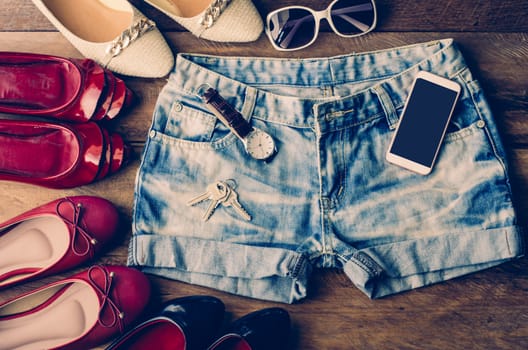 clothing for women, placed on a wooden floor.