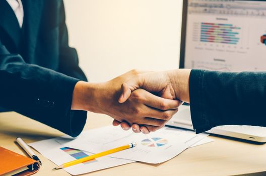 Handshake between joint venture businessmen after good management and have good concept 