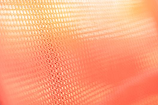 fabric orange colored background with light penetrating through 