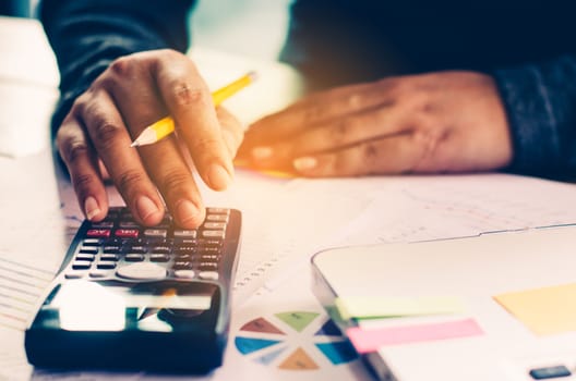 businessman are working with a calculator and laptop. in office business concept
