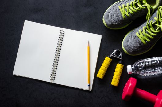 fitness concept with Exercise Equipment on wooden background.