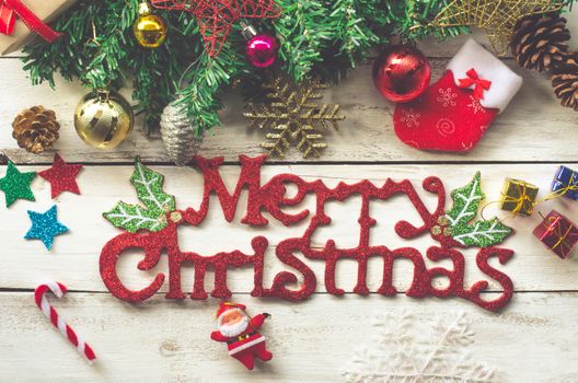 Christmas decorations and "Merry christmas" greetings on a wood white background.