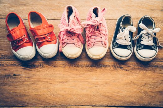 Shoes for children on wooden floor - lifestyle