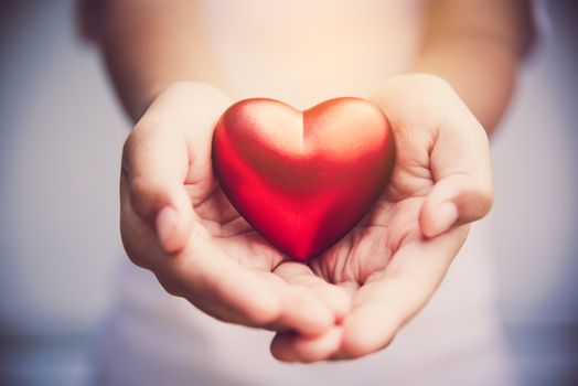 Hand give red heart for love