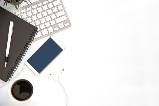 Top view with copy space, working desk with laptop,cell phone,notebook pencil and coffee on white background