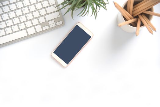 Top view with copy space, working desk with laptop,cell phone,notebook pencil and coffee on white background
