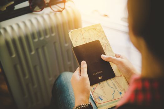 People holding passports, map for travel with luggage for the trip 