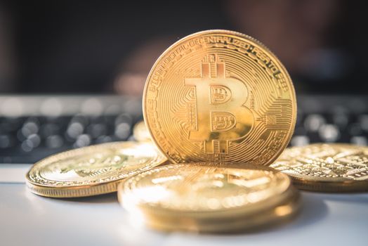 close-up bitcoin and its business-class laptop work and bring transactions across the network and help with today's business management,
