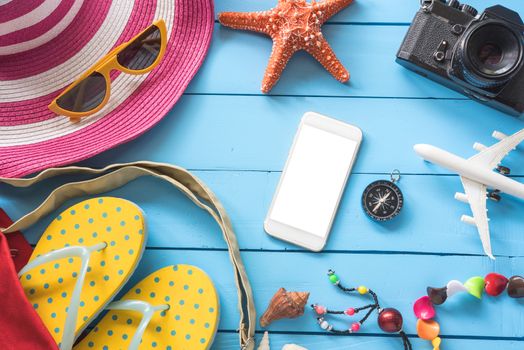 Accessories with woman for travel summer. On blue wooden floor