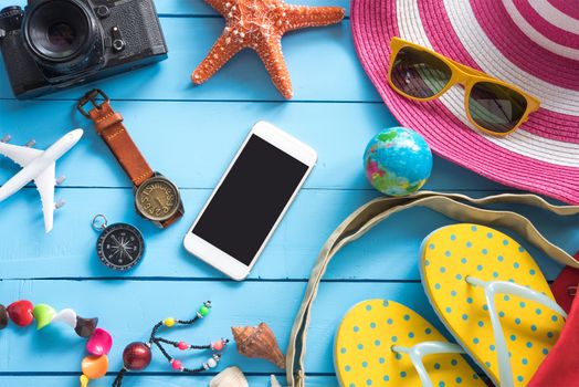 Accessories with woman for travel summer. On blue wooden floor