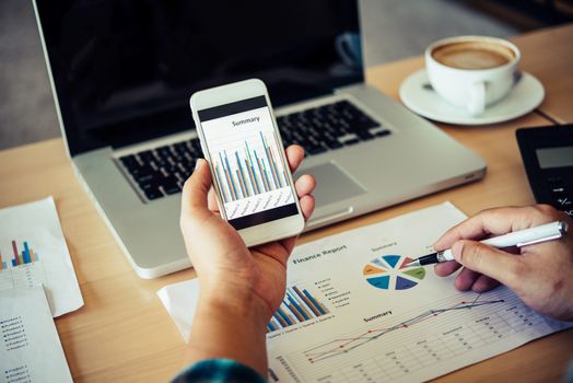 documents graphs and smartphone , analyzing investment chart working in office.Meeting report in progress. Business work concept picture of economy, market, office,money a