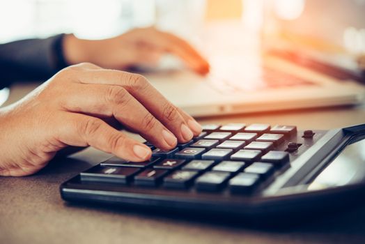 Business people are working on accounts in business analysis with graphs and documentation laptop in office 