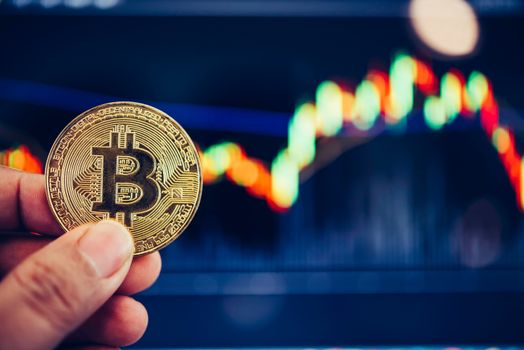 Bitcoin gold coins coin and defocused chart background