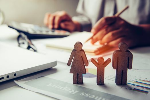Family life icon and there are businessman working with laptop at background 