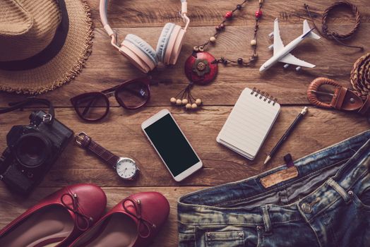 clothing for women, placed on a wooden floor for travel