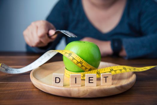 Young women are deciding to eat fruit to help them lose weight.- concept diet