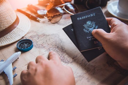 Travelers are planning a trip by searching the route on the map and preparing the necessary travel 