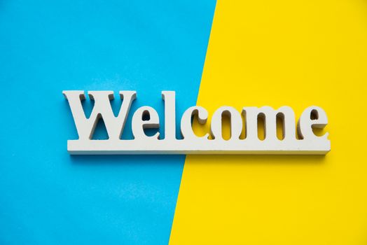 Top view for "Welcome" sign on a colorful background.