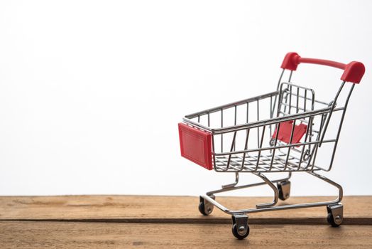 Mini shopping cart on table for work for work to shopping online concept 