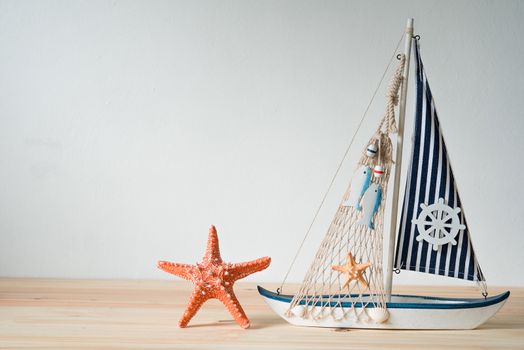 Replica shells, yacht simulators, resting on a wooden tripod concept.