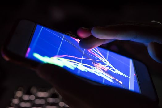 businessman checking stock charts on a mobile device. 