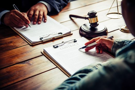 Signing a contract between different business people accept each other in agreement.