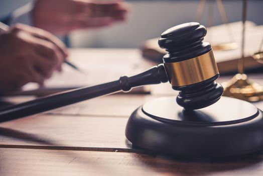 Law theme, mallet of the judge, law enforcement officers, evidence-based cases, and documents taken into account.