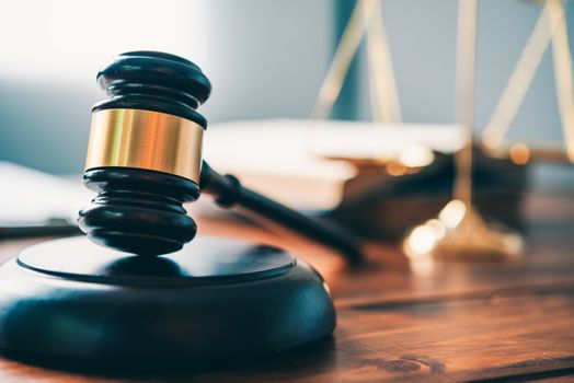 Law theme, mallet of the judge, law enforcement officers, evidence-based cases, and documents taken into account.