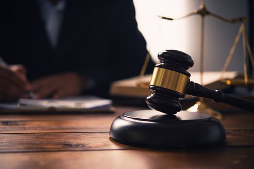 Law theme, mallet of the judge, law enforcement officers, evidence-based cases, and documents taken into account.