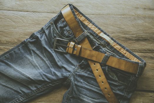 Jeans for men on a wooden floor