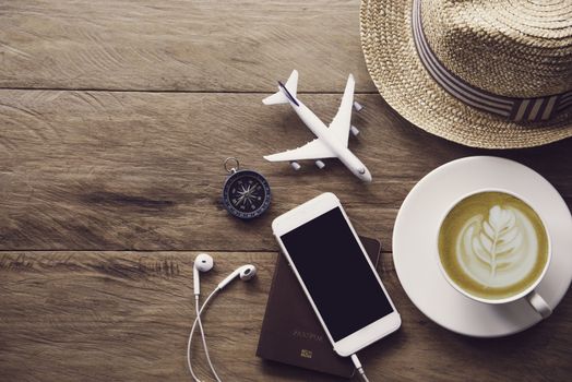 top view  passport and smartphone on wooden table, for travel concept