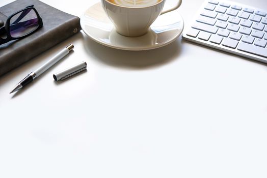 copy space, working desk with laptop,cell phone,notebook pencil and coffee on white background