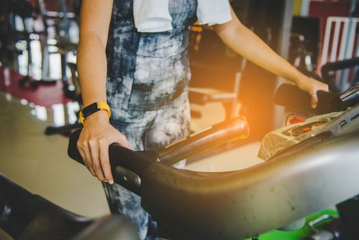 Young women exercise in a professional gym with a selection of exercise equipment.